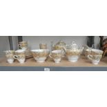 19TH CENTURY ENGLISH PORCELAIN CREAM AND GILT TEA SERVICE ON 1 SHELF