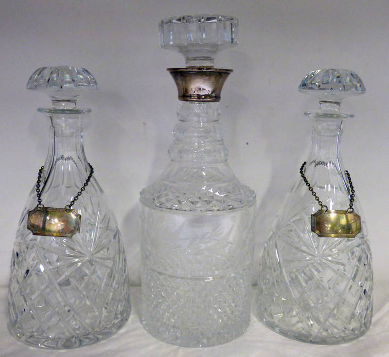 SILVER MOUNTED CUT GLASS DECANTER AND 2 CUT GLASS DECANTERS WITH SILVER BOTTLE LABELS