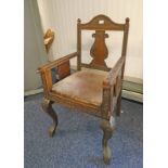 19TH CENTURY MIDDLE EASTERN ARMCHAIR WITH CARVED DECORATION ON SHAPED SUPPORTS