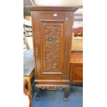 EARLY 20TH CENTURY MAHOGANY CABINET ON STAND WITH CARVED PANEL DOOR