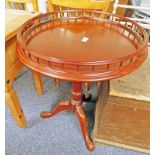 20TH CENTURY MAHOGANY GALLERIED FLIP TOP CIRCULAR TABLE WITH CARVED SPREADING SUPPORTS