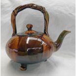 19TH CENTURY TREACLE GLAZED DUNMORE POTTERY TEAPOT WITH TWIST HANDLE ON 3 SUPPORTS - 20CM TALL