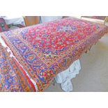 RED GROUND FLORAL DECORATED MIDDLE EASTERN CARPET 300 X 195CM