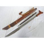 A MANDAU WITH CARVED WOODEN HILT AND HEAVY BLADE WITH BRASS DOT DECORATION 63CM LONG,