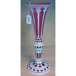 LATE 19TH CENTURY RED GLASS VASE WITH WHITE ENAMEL & GILT DECORATION WITH FLUTED TOP - 33 CM TALL