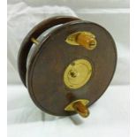 A 4 1/2'' HARDWOOD AND BRASS STARBACK REEL BY 'CARTER AND CO LTD' OF LONDON