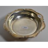 A silver bowl, by Atkin Bros. Sheffield, 1944, shaped rim, raised on four supports, approx. 22ozs