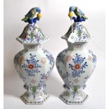 A pair of Dutch Delft vases and covers 20th century. Both vase tops with small hairline crack and