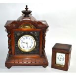 A walnut cased striking mantle clock with floral embossed front and side panels retailed by J.W.