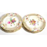 Eight Dresden hand-painted floral plates with pierced rims