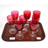 A set of eight Victorian cranberry glass wines, each etched with a greyhound coat of arms