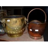 A Victorian brass log bin with three ring lion mask handles, together with a copper helmet form coal