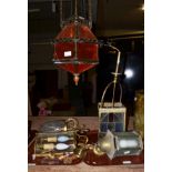 A middle Eastern style brass hanging lantern, a brass and coloured glass four-sided lantern, with