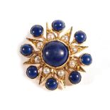 A Lapis Lazuli and Split Pearl Star Brooch, a round cabochon lapis lazuli to radial arms set with