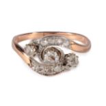 A Rose Cut Diamond Crossover Ring, three graduated rose cut diamonds in claw settings, within