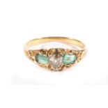 An Emerald and Diamond Three Stone Ring, an old cut diamond spaced by octagonal cut emeralds, in a