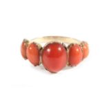 A Coral Ring, five graduated oval coral, in collet settings, finger size M . The ring is in good