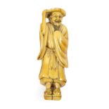 A Japanese Ivory Netsuke, Edo period, standing holding a lotus leaf on his head, wearing getas on