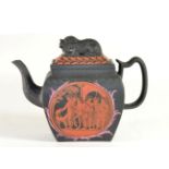 A Black Basalt Teapot and Cover, circa 1810, of bombé rectangular form with recumbent lion finial,
