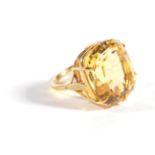 An 18 Carat Gold Citrine Ring, a cushion mixed cut citrine in a claw setting, to forked shoulders,