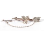 A Diamond Fly and Arrow Brooch, modelled as a fly with ruby set eyes and diamond set body, to a