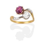 A Ruby and Diamond Crossover Ring, an old cut diamond and a round cut ruby in claw settings, to