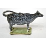 A Pearlware Cow Creamer and Stopper, circa 1810, the standing beast with black sponged markings,