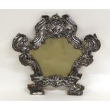 An Italian White Metal Mounted Mirror, apparently unmarked probably 18th Century, with repousse