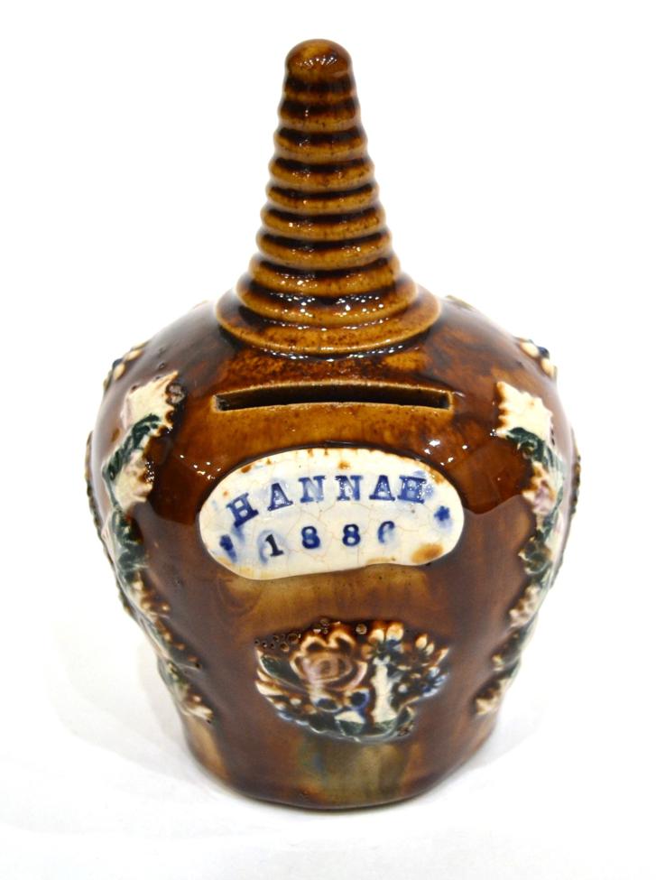 A Measham Bargeware Money Box, dated 1886, of baluster form with ribbed conical finial, inscribed