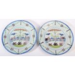 A Pair of English Delft Plates, probably Lambeth, circa 1780, painted in colours with a fenced