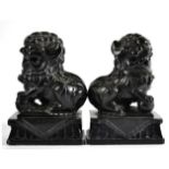 A Pair of Chinese Carved Black Slate Dogs of Fo, late 19th/20th century, of traditional form, on