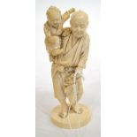 A Japanese Ivory Okimono, Meiji period, as a farmer holding a small child in his right arm, on an