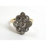 An Early Twentieth Century Diamond Cluster Ring, an old cut diamond in a rubbed over setting, within