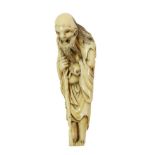 A Japanese Ivory Netsuke, Edo period, as a Sennin leaning on a staff, 8cm highSome staining and