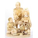 A Japanese Ivory Okimono, Meiji period, as musicians, the father playing a biwa, the son drums