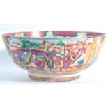 A Chinese Porcelain Punch Bowl, Qianlong, painted in the Mandarin palette with figures in gardens on