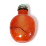 A Chinese Carnelian Snuff Bottle, of ovoid form, engraved with scrolling foliage, with silver