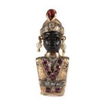 A Twentieth Century Gem Set Blackamoor Brooch, modelled with a carved ebony face and wearing a