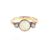 An Opal and Diamond Three Stone Ring, a grain set round cabochon opal, spaced by old cut diamonds,