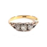 An Old Cut Diamond Three Stone Ring, graduated diamonds, in a carved setting, total estimated