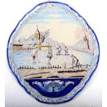 A Dutch Delft Wall Plaque, 19th century, of shaped oval form, painted in colours with figures