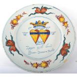 A Presentation Delft Charger, dated 1767, painted in colours with a crowned pair of hearts inscribed