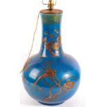 A Chinese Blue Ground Bottle Vase, 19th century, with applied lappet decoration of flowering
