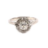 An Old Cut Diamond Cluster Ring, a principal old cut diamond within a border of smaller old cut