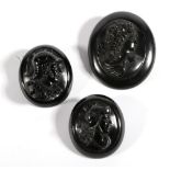 Three Jet Cameo Brooches, two carved depicting Roman soldiers, measuring 5.6cm by 4.6cm and