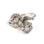 A Diamond Double Cluster Ring, two clusters of round brilliant cut diamonds, to diamond set scroll