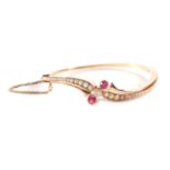 A Victorian Ruby, Diamond and Pearl Bangle, an old cut diamond spaced by two round cut rubies, to