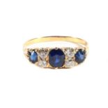 A Sapphire and Diamond Ring, three oval cut sapphires spaced by pairs of old cut diamonds, total