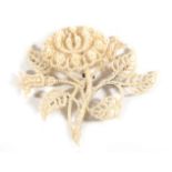 A Seed Pearl Spray Brooch, as a flower head and leaves to a mother-of-pearl frame, measures 7cm by