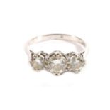 A Diamond Three Stone Ring, graduated round brilliant cut diamonds in claw settings, to tapering